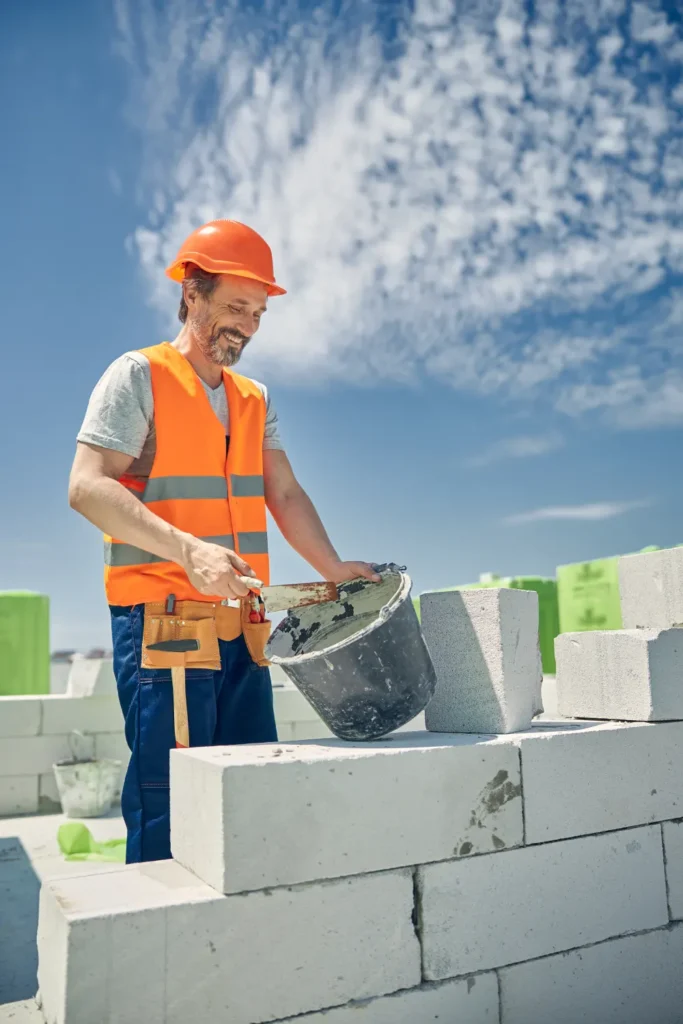 bricklayer in a hard hat laying